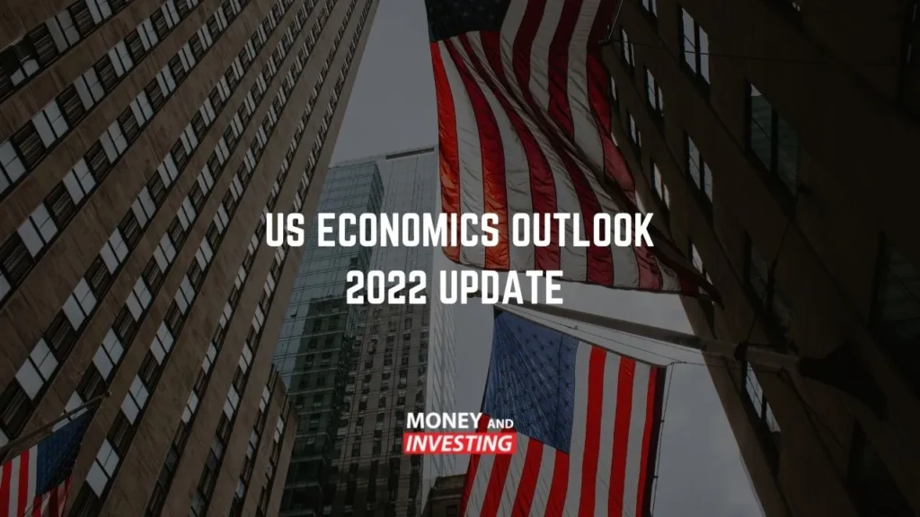 Tall buildings and American flags with the text “US ECONOMICS OUTLOOK 2022 UPDATE” and the “MONEY AND INVESTING” logo.